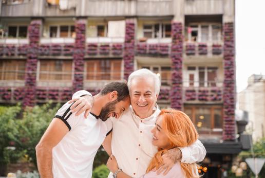 The old man hugged his grandson and granddaughter.